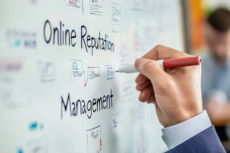 A person writes on a whiteboard with the words "Online Reputation Management," various notes, and diagrams in blue ink, brainstorming strategies like how to remove items from LexisNexis during a planning session.