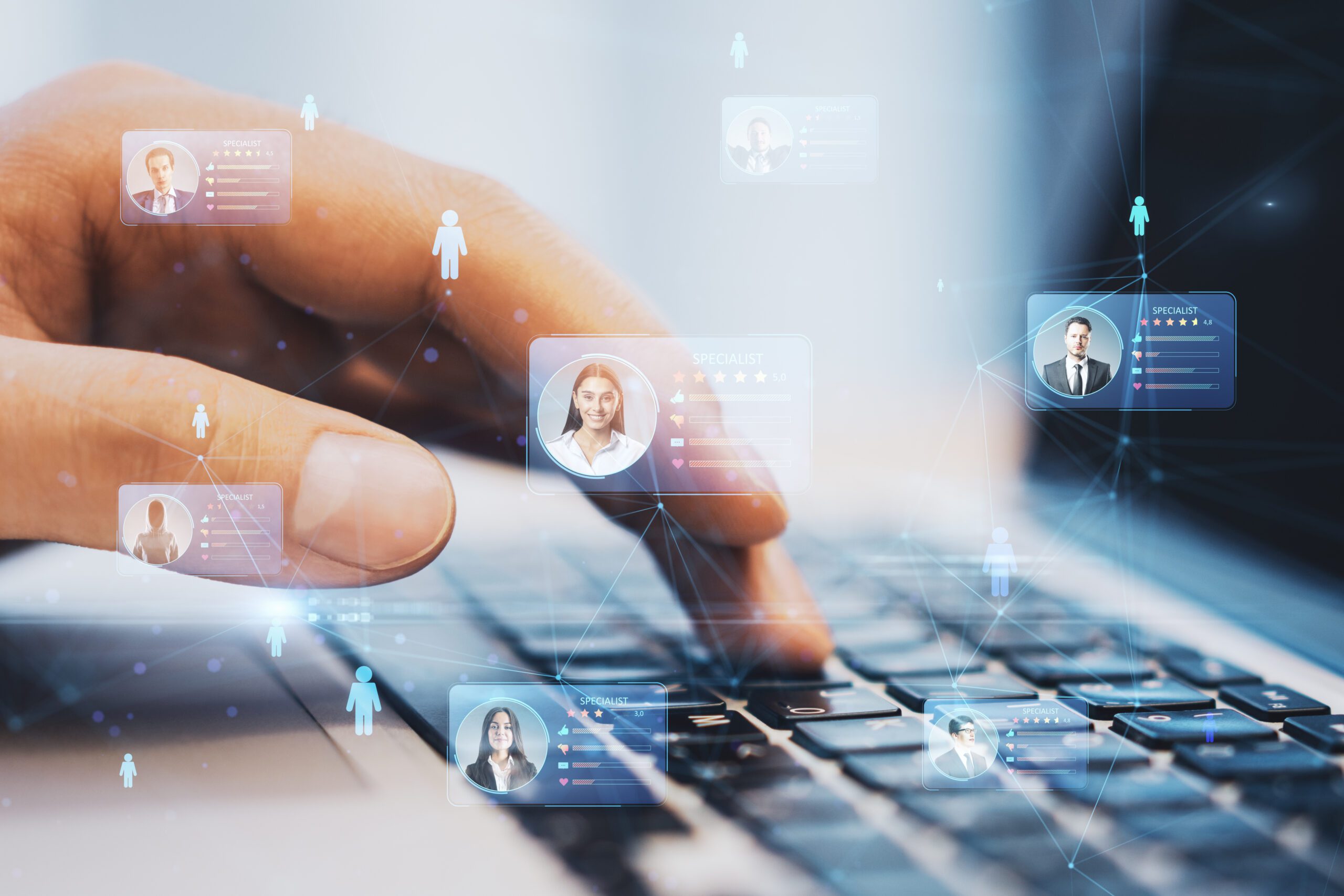 A hand typing on a laptop keyboard with digital profile images and network icons floating above, symbolizing a virtual connection or digital networking concept. The scene has a futuristic vibe with soft lighting and a slightly blurred effect.