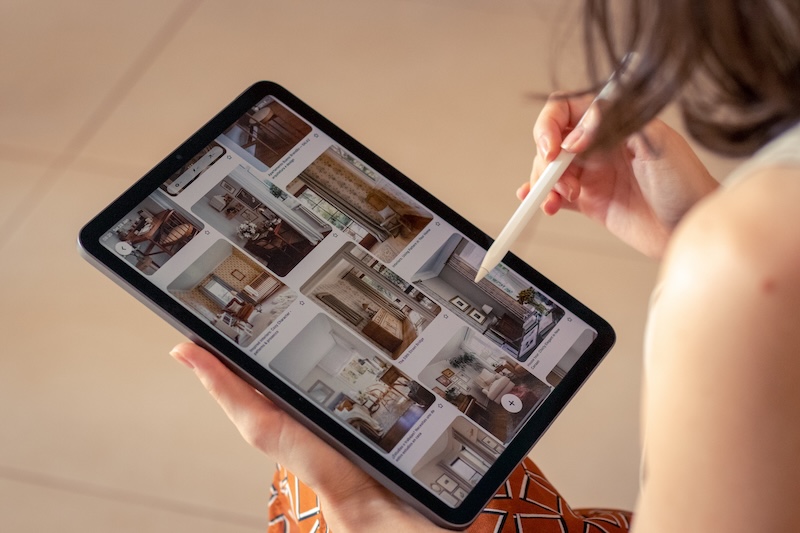A person scans through their Pinterest saves on a tablet.